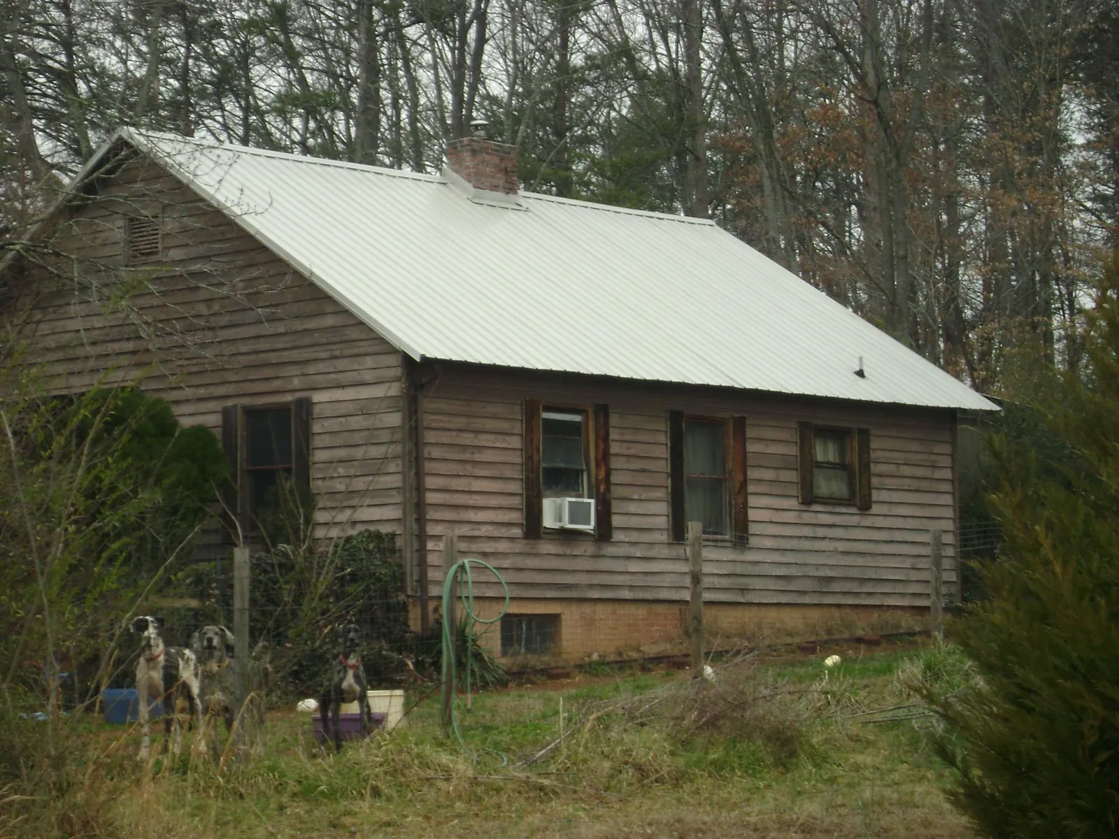 White metal roof on an old wood sided farmhouse, from a Asphalt Shingle Roof Repair job in Prairie